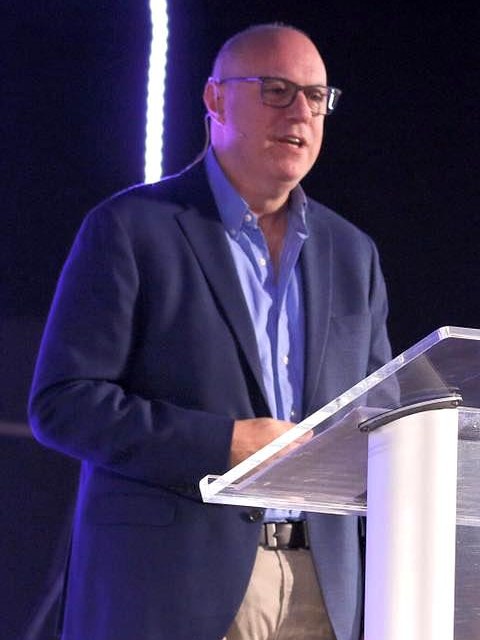 Peter Ramis, founder of FaithCore Lab, speaking at a podium